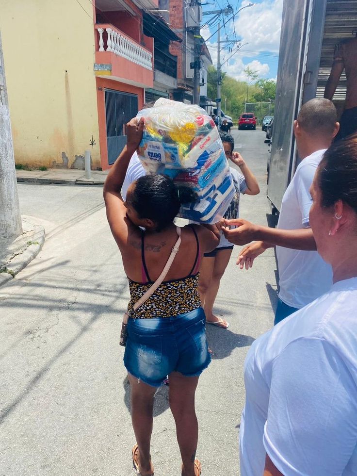 Família recebendo a cesta básica entregue pelos voluntários